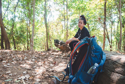 Ttraveler with backpack hiking in tropical rain forest.