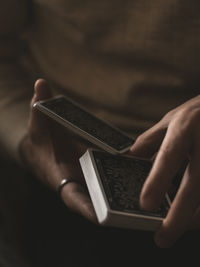 Close-up of man holding cards