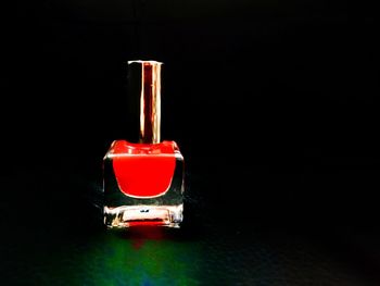 Close-up of electric lamp on table against black background