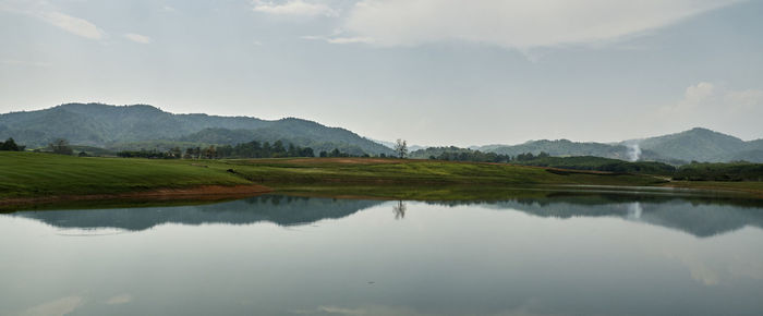 Scenic view of lake and mountains against sky