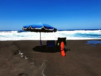 Lifeguard hut on beach against sky