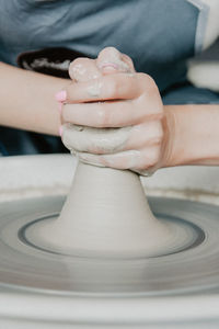 Midsection of woman at pottery workshop