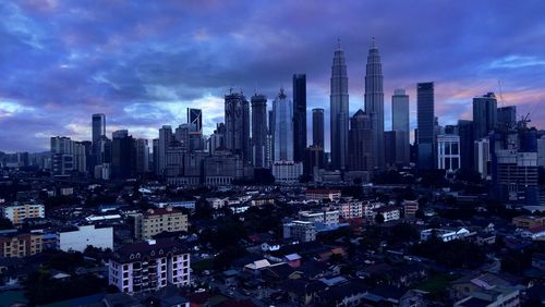 Aerial view of modern buildings in city against sky