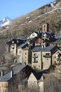 Houses in town against sky during winter