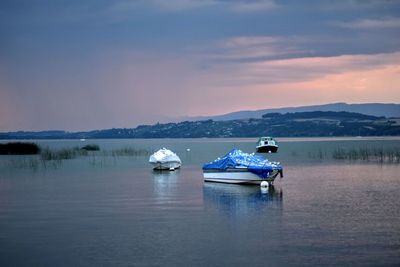 Boat in lake against sky