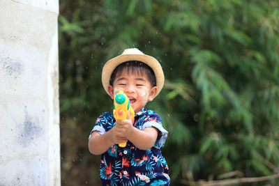 Portrait of boy holding hat