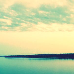 Scenic view of lake against cloudy sky