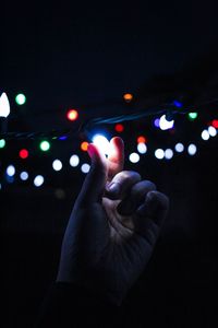 Close-up of hand holding illuminated lights