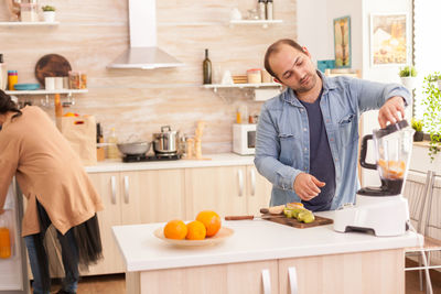 Man preparing juice in kitchen