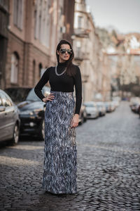 Young woman standing on street in city