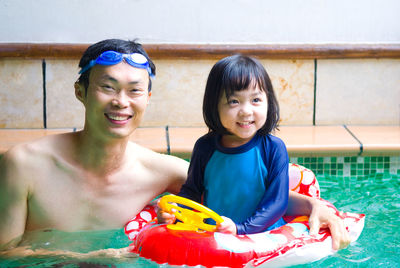 Father and daughter in swimming pool