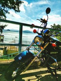 Close-up of bicycle parked against sea