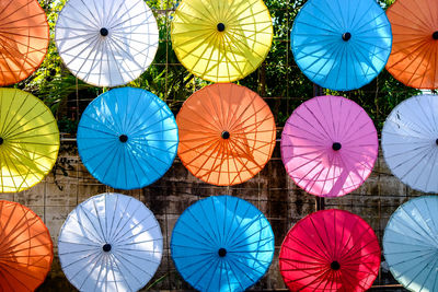 Low angle view of multi colored umbrellas hanging