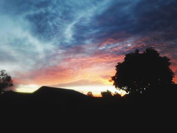 Low angle view of silhouette trees against sky during sunset