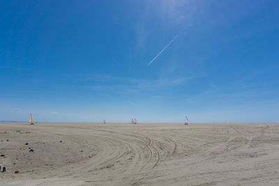 Scenic view of beach against blue sky