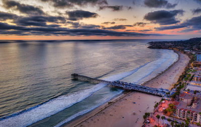 Drone image of crystal pier in san diego during cloudy sunset. california beach scene.