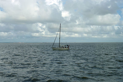 Sailboat in sea against sky