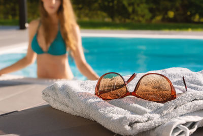 Woman relaxing on swimming pool at beach