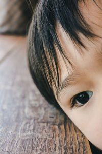 Close-up of child at wooden table