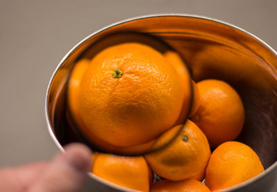 Close-up of hand holding orange