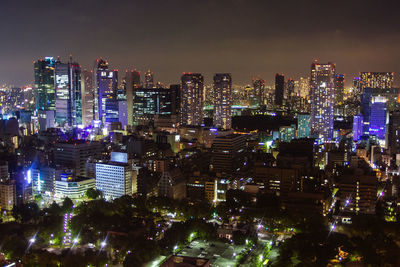 High angle view of illuminated buildings in city at night