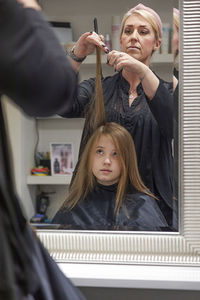 Girl having her hair cut
