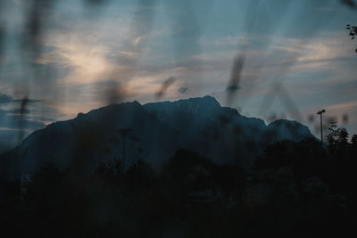 Scenic view of silhouette mountains against sky at sunset