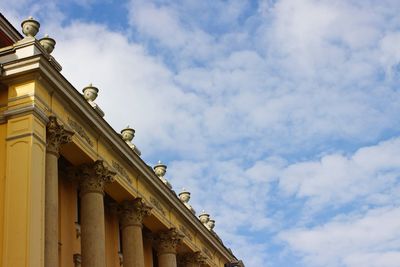 Low angle view of historical building against cloudy sky