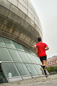 Young man running fast in the park