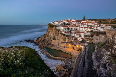 High angle view of sea and buildings against sky