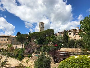 Buildings in town against sky