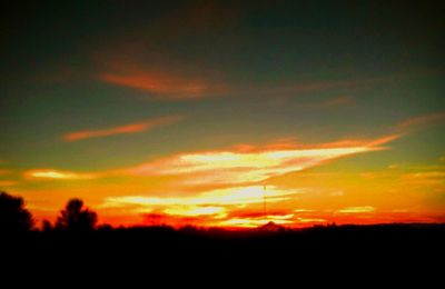 Dramatic sky over silhouette landscape