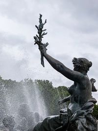 Low angle view of statue against fountain