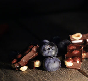 Close-up of fruits on table against black background