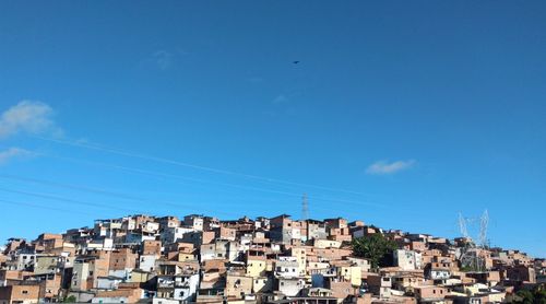 Low angle view of residential buildings against blue sky