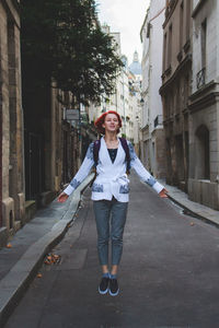 Portrait of smiling young woman standing on street