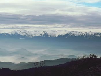 Scenic view of snowcapped mountains against sky