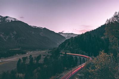 High angle view of road by mountains against sky