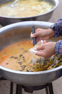 Midsection of man preparing food in kitchen