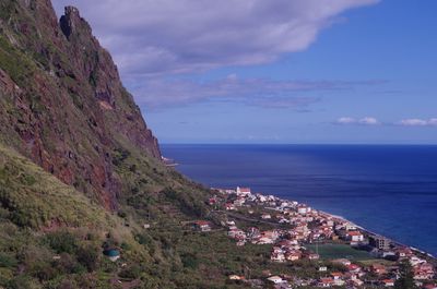 Scenic view of sea and mountains against sky