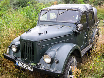 Abandoned car on field