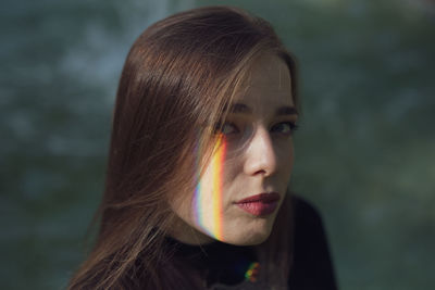 Close-up portrait of young woman with spectrum