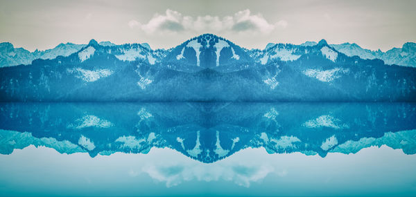 Close-up of frozen lake against mountain range