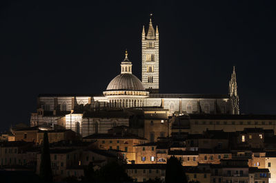 Illuminated buildings in city at night