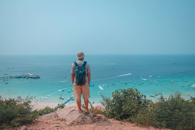 Man looking at sea against clear sky