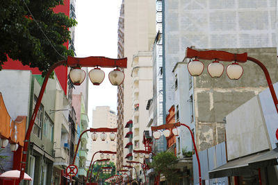 Low angle view of street light against building