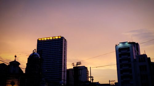 Low angle view of building against sky at sunset