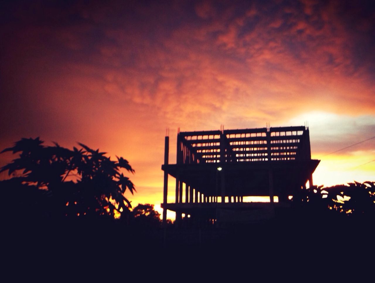 sunset, silhouette, sky, tree, built structure, orange color, cloud - sky, architecture, low angle view, tranquility, nature, outdoors, beauty in nature, dusk, no people, building exterior, scenics, tranquil scene, bench, idyllic