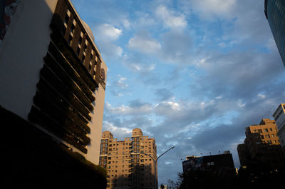 Low angle view of buildings against sky during sunset