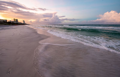 Scenic view of beach against sky during sunset